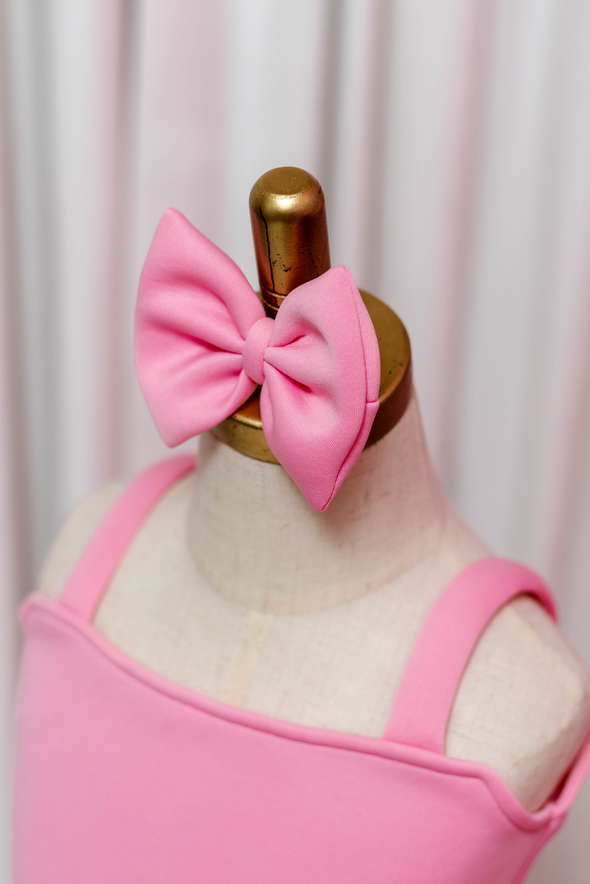 close up photo showing pink matching bow for side ruffle dress