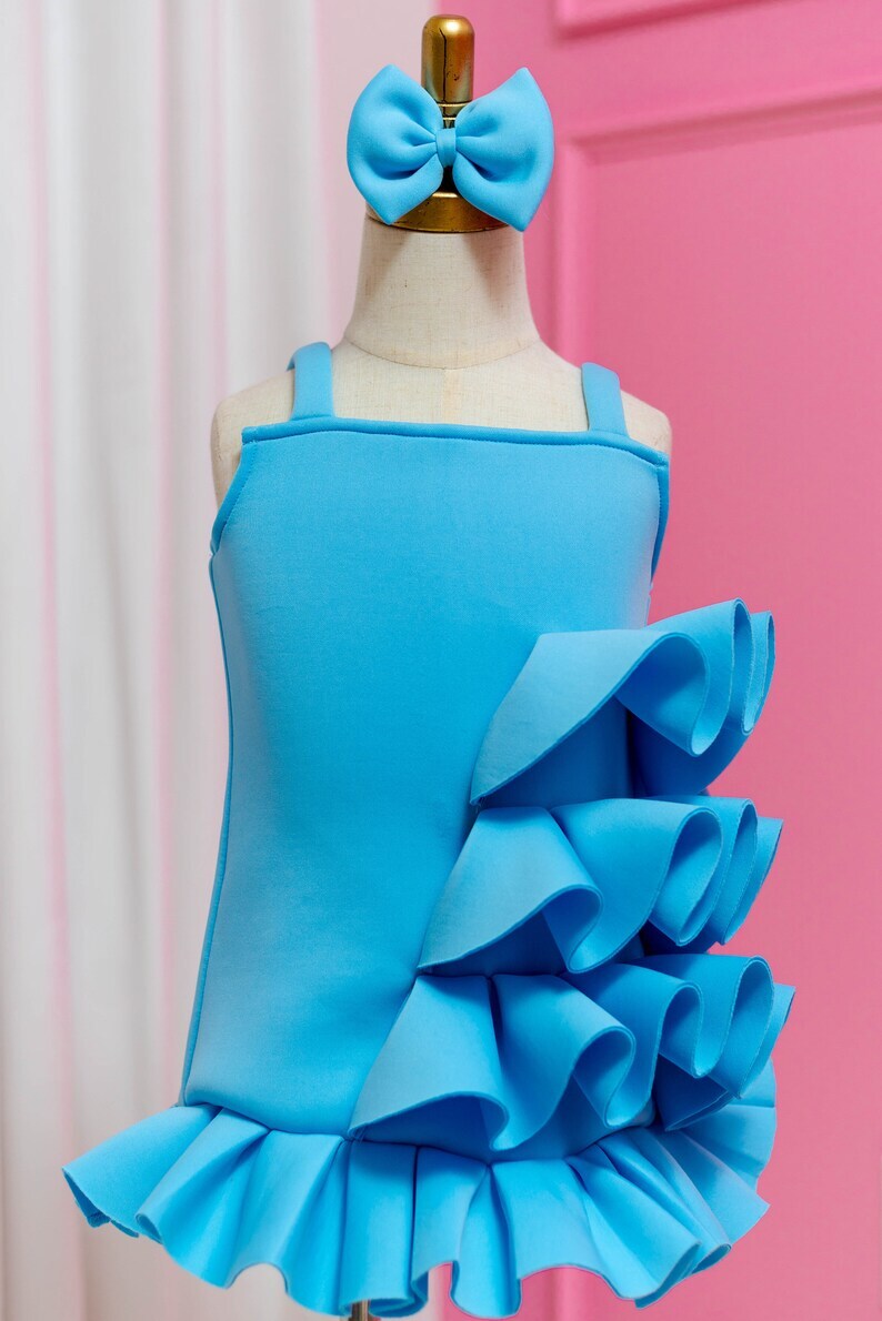 sky blue side ruffle dress displayed on fashion stand