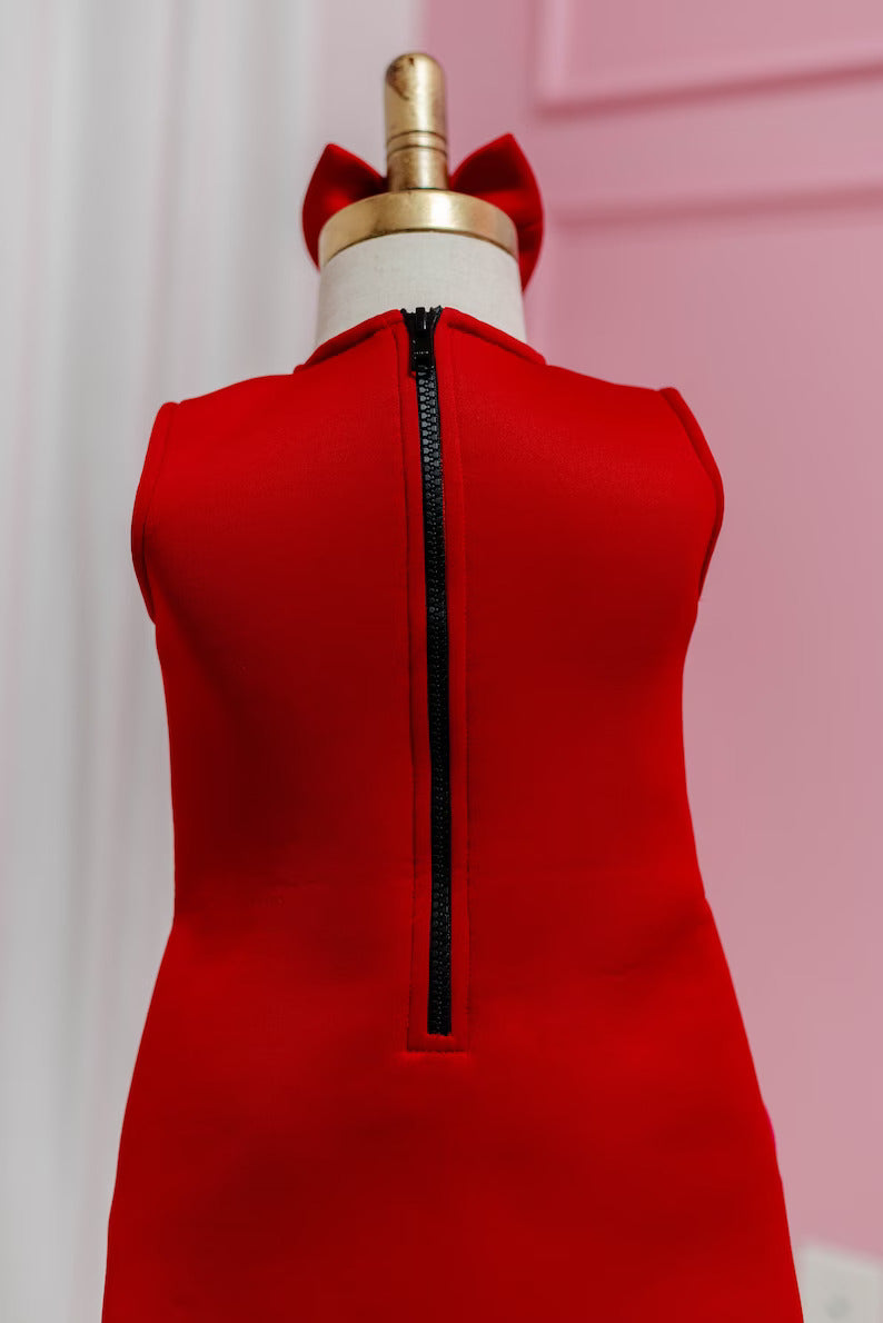 rearview of red block bow dress with black zipper