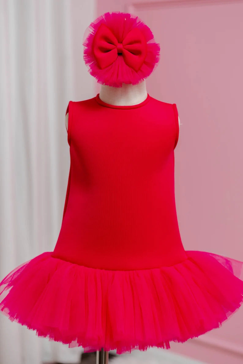 Fuchsia pink toddler dress with matching headpiece, displayed on fashion stand