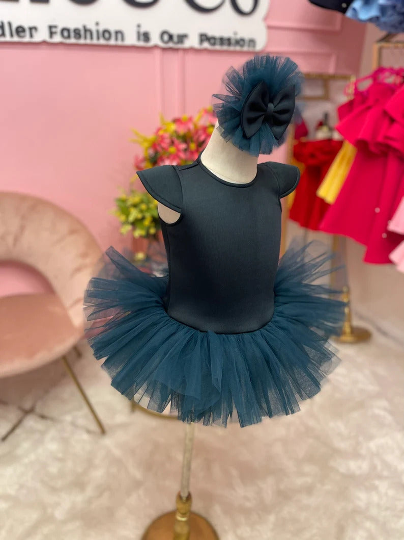 Emerald green ballerina dress with matching head piece displayed on a fashion stand