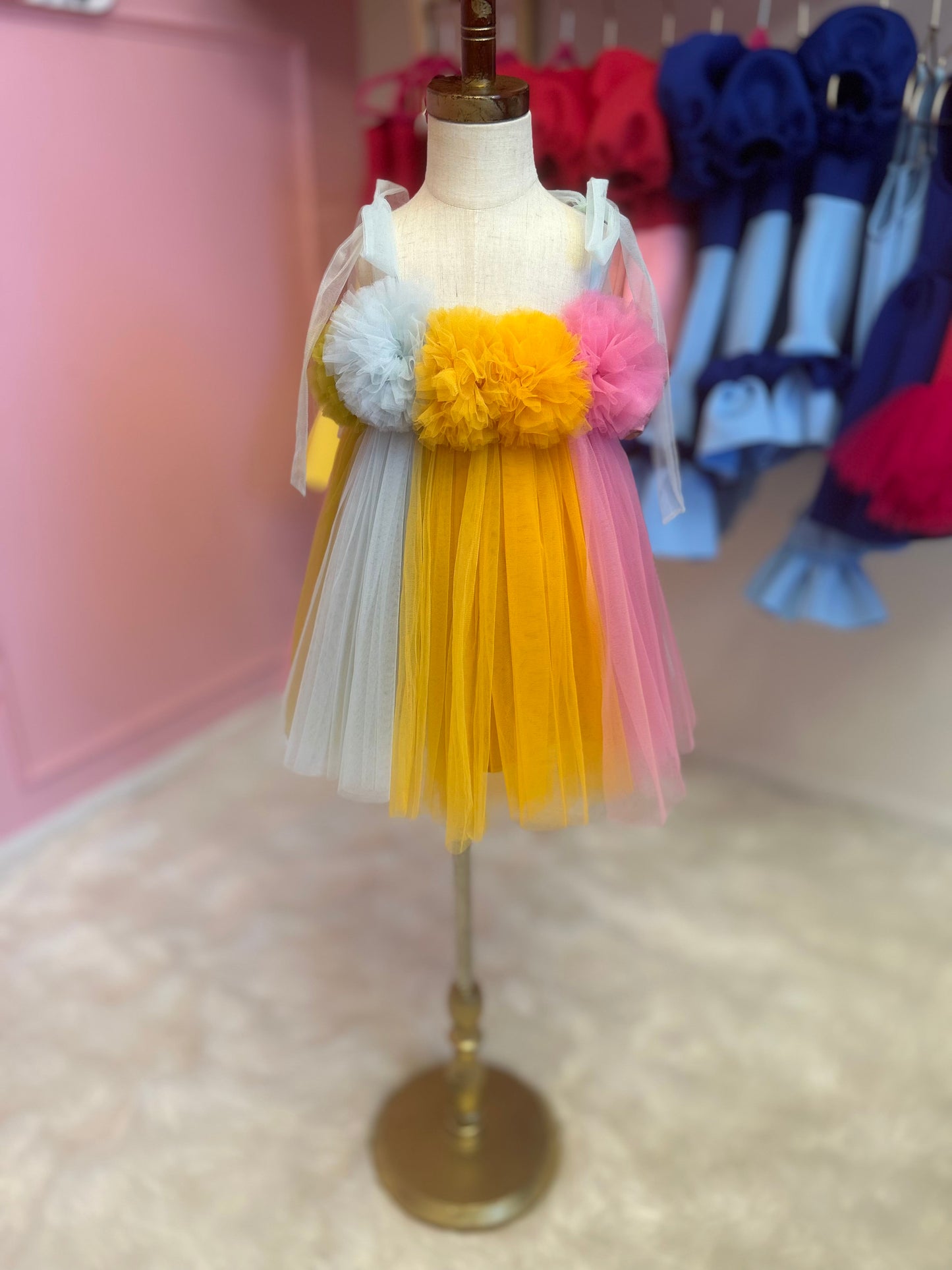 multi-coloured dreamy tulle dress for little girl, displayed on fashion stand
