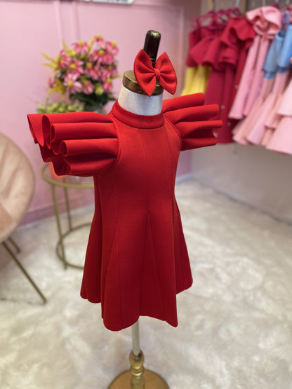 side view of Red ruffle sleeve dress with matching hair bow displayed on fashion stand