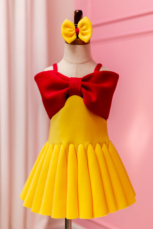 Fuchsia pink and yellow big bow dress displayed on design stand