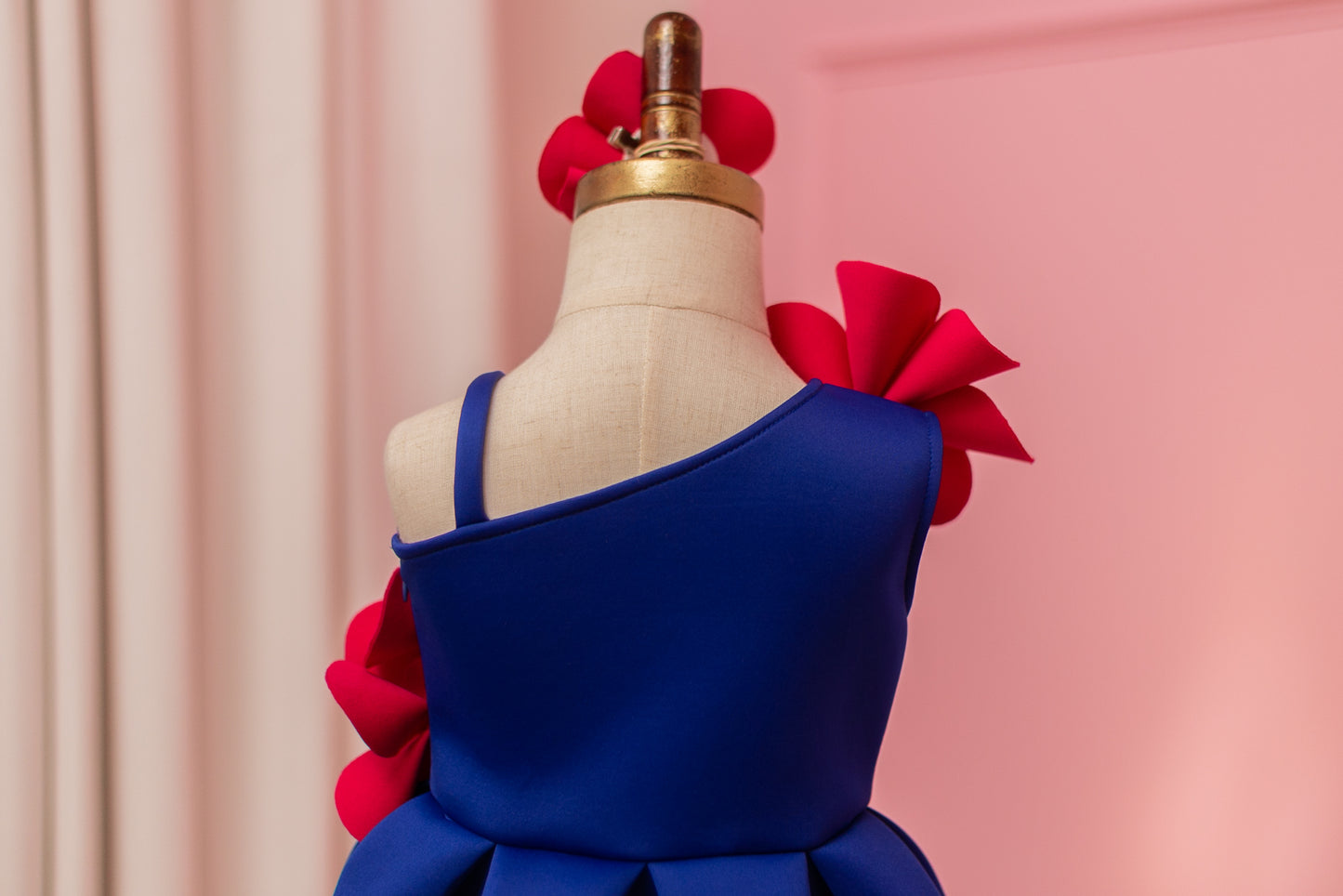 rear view of one shoulder blue and fuchsia pink dress