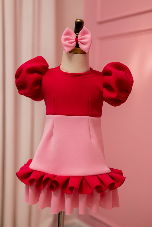 fuchsia pink ruffle pearl dress with puffy shoulder and matching head bow displayed on fashion stand