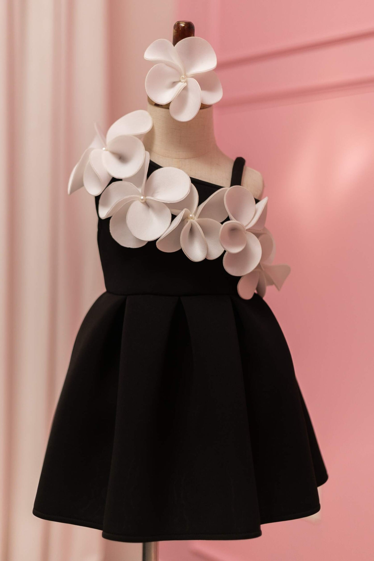 Black and white one shoulder floral dress, displayed on fashion stand