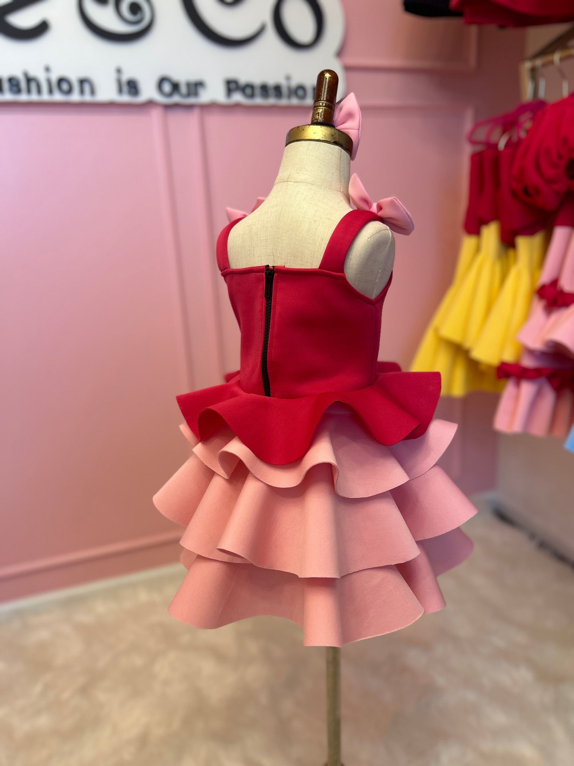 rearview of ruffle dress displayed on fashion stand