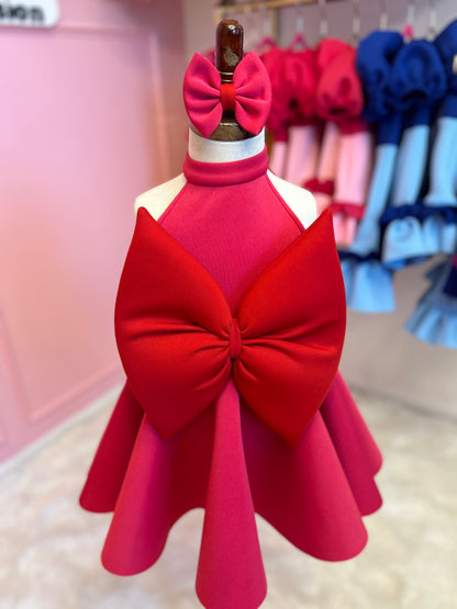 sleeveless halter neck red bow dress displayed on fashion stand